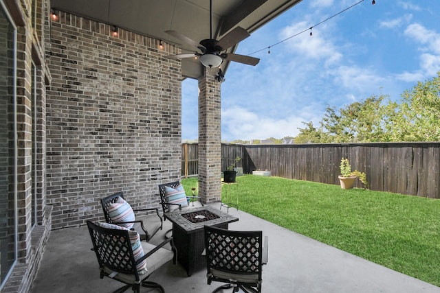 view of patio / terrace with ceiling fan and an outdoor fire pit