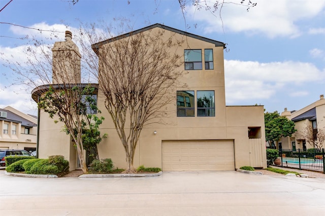 view of front of house with a garage and a swimming pool