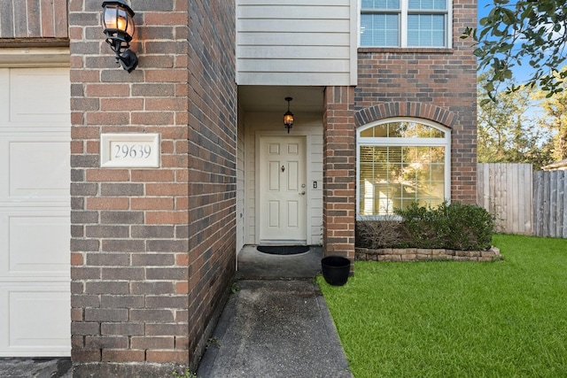 view of exterior entry with a lawn