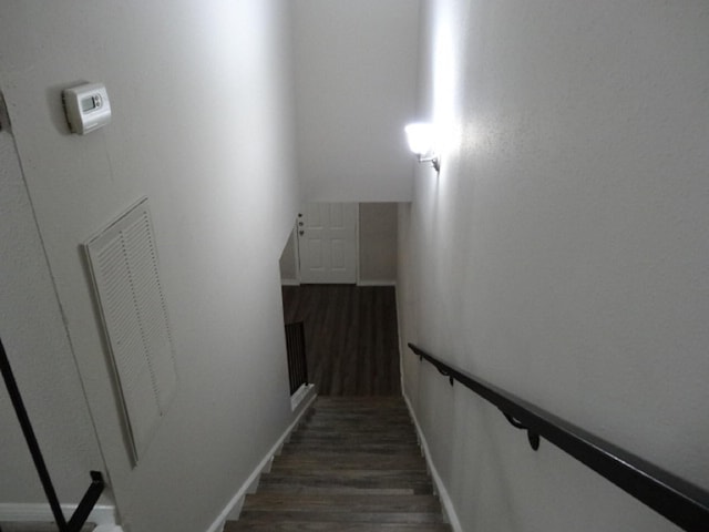 stairs with baseboards and wood finished floors