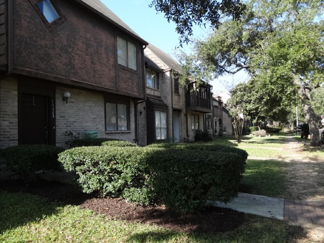 exterior space featuring brick siding