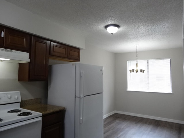 kitchen with white appliances, baseboards, a chandelier, under cabinet range hood, and light wood finished floors