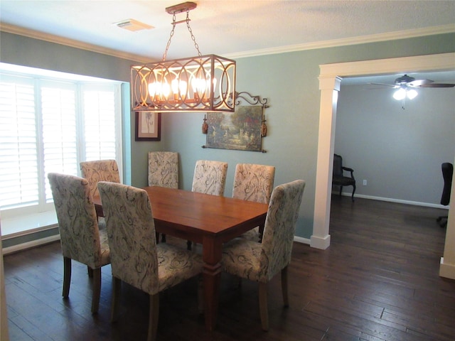 dining space featuring ceiling fan with notable chandelier, ornamental molding, and dark wood-type flooring