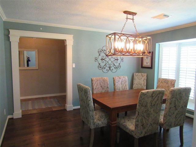 dining area with a textured ceiling, dark hardwood / wood-style floors, and crown molding