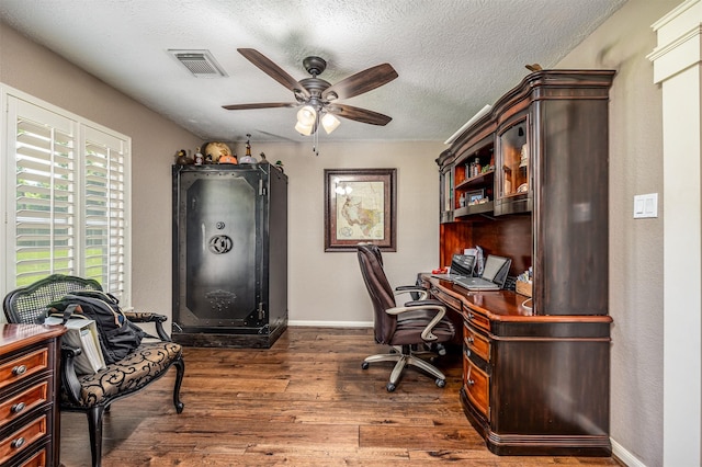 office featuring ceiling fan, dark hardwood / wood-style flooring, and a textured ceiling