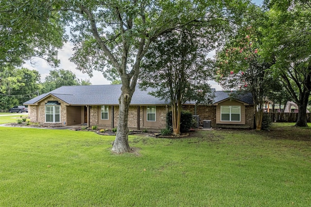 ranch-style home with a front lawn and central AC unit