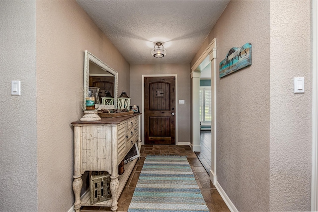 doorway with a textured ceiling