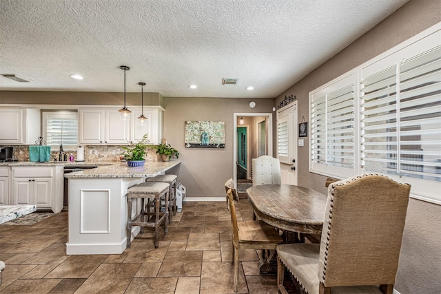 dining area featuring a textured ceiling