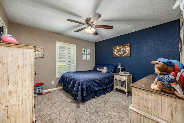 bedroom with carpet, ceiling fan, and a textured ceiling