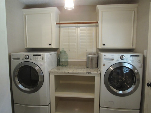 washroom featuring cabinets and washer and dryer