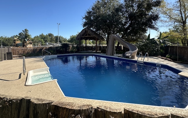 view of pool featuring a gazebo and a water slide