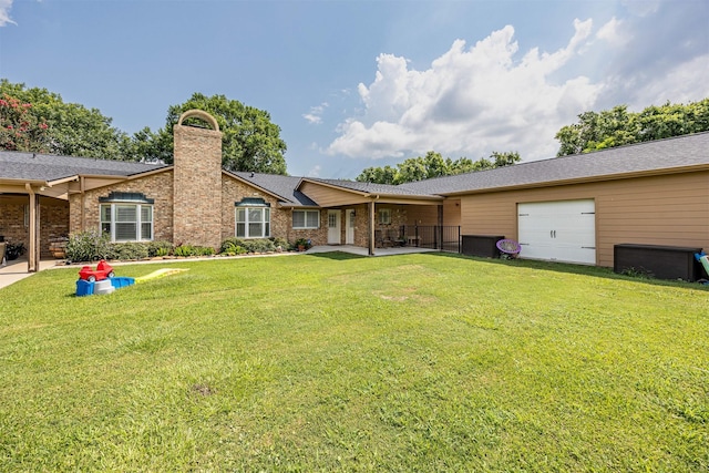 exterior space with a garage and a yard