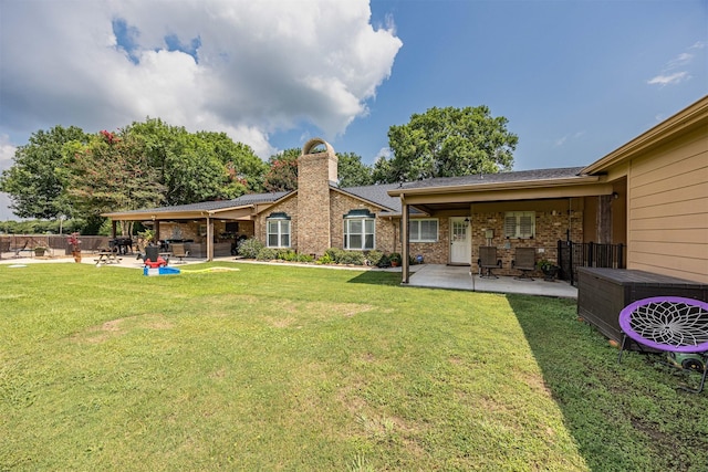 rear view of house with a patio area, a yard, and ac unit