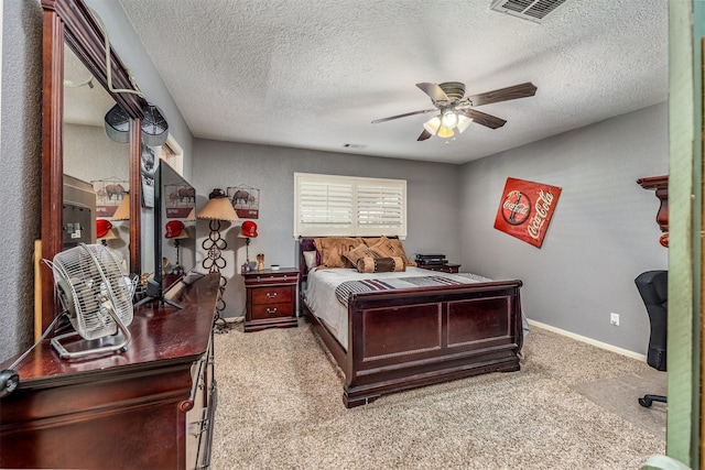 carpeted bedroom with ceiling fan and a textured ceiling