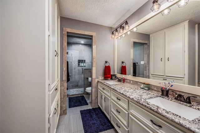 bathroom with vanity, a textured ceiling, toilet, and an enclosed shower