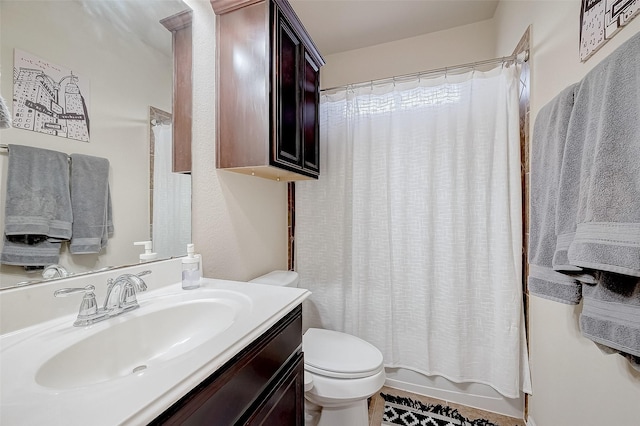 full bathroom with vanity, shower / bath combo, and toilet