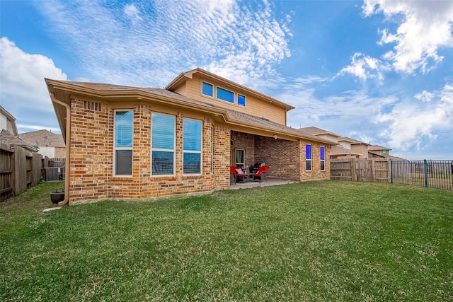 back of property featuring a patio area and a yard