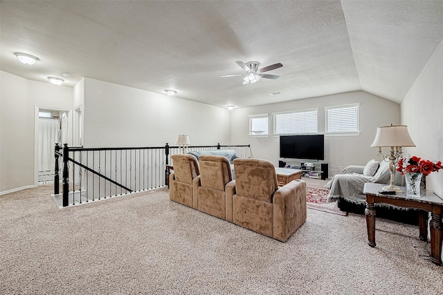 living room featuring a textured ceiling, ceiling fan, lofted ceiling, and light carpet