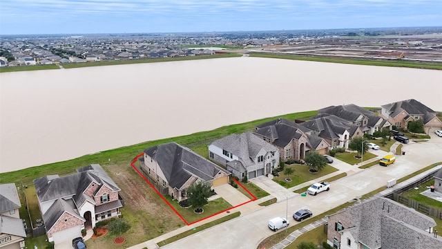 drone / aerial view featuring a residential view and a water view