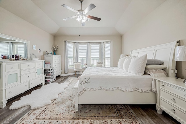 bedroom with a ceiling fan, lofted ceiling, and dark wood finished floors