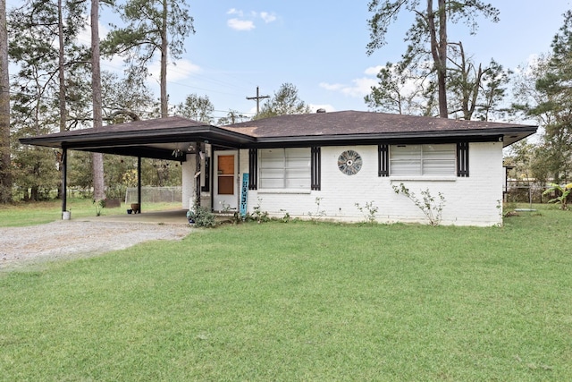 view of front of house with a front lawn and a carport