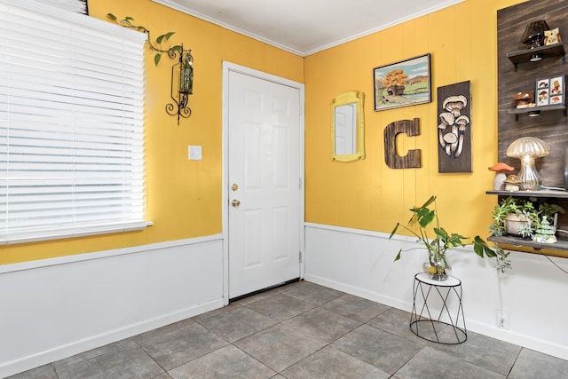 entryway with tile patterned flooring and ornamental molding