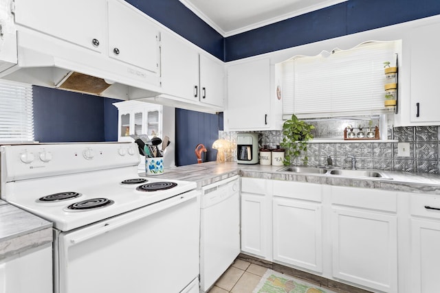 kitchen featuring white cabinetry, sink, tasteful backsplash, white appliances, and light tile patterned floors