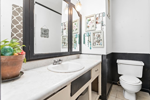 bathroom with tile patterned flooring, vanity, and toilet