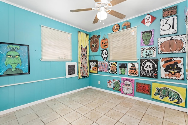 recreation room with ceiling fan, light tile patterned floors, and ornamental molding