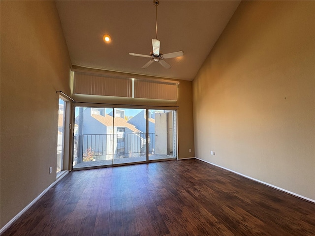 unfurnished room featuring dark wood finished floors, high vaulted ceiling, baseboards, and ceiling fan