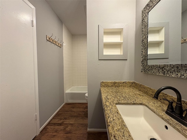 full bath with vanity, toilet, wood finished floors, and baseboards