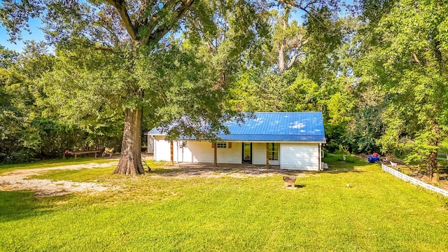 rear view of property featuring a lawn