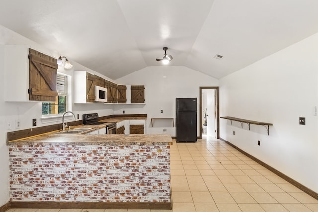 kitchen featuring sink, kitchen peninsula, lofted ceiling, light tile patterned floors, and black appliances