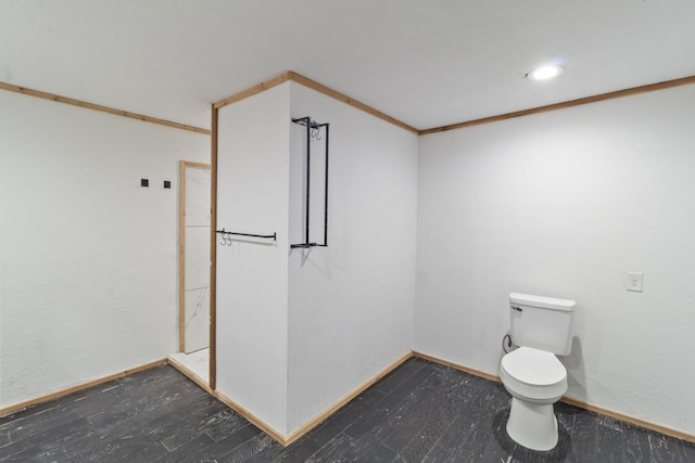 bathroom with toilet, ornamental molding, and hardwood / wood-style flooring