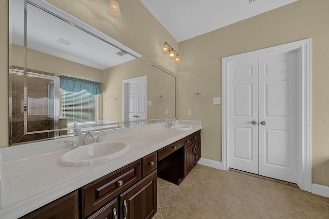 bathroom with vanity, tile patterned floors, and a shower with door