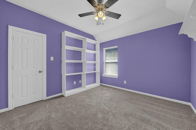 unfurnished room featuring ceiling fan, carpet, and lofted ceiling