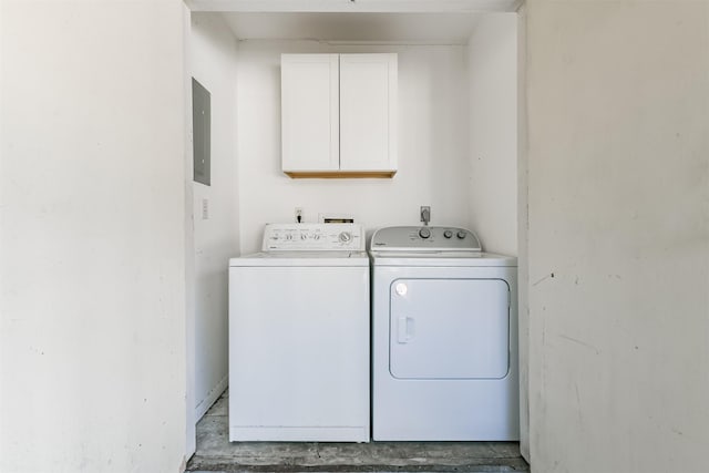 laundry room featuring washing machine and dryer, electric panel, and cabinets