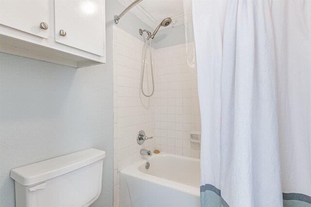 bathroom with shower / bath combo with shower curtain and toilet