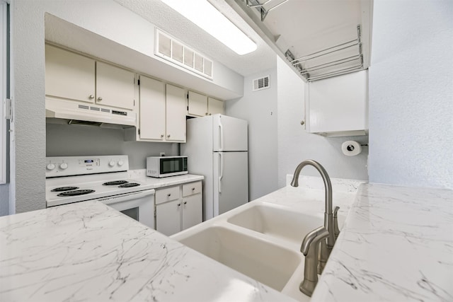 kitchen with sink and white appliances