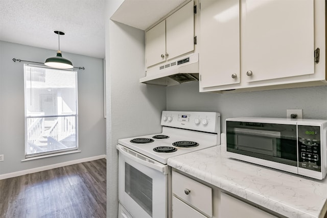 kitchen featuring pendant lighting, dark hardwood / wood-style floors, white range with electric stovetop, and a healthy amount of sunlight