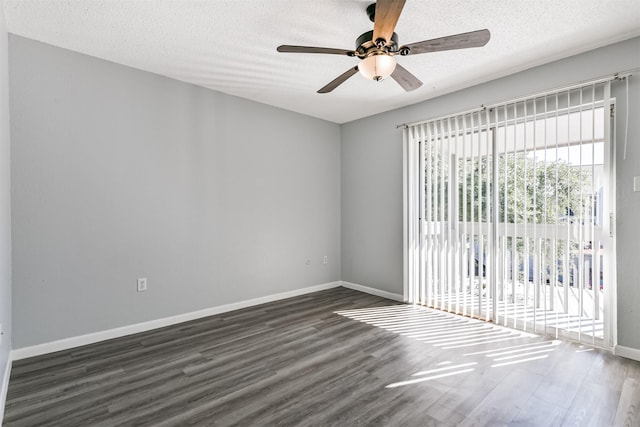 unfurnished room with ceiling fan, dark hardwood / wood-style flooring, and a textured ceiling