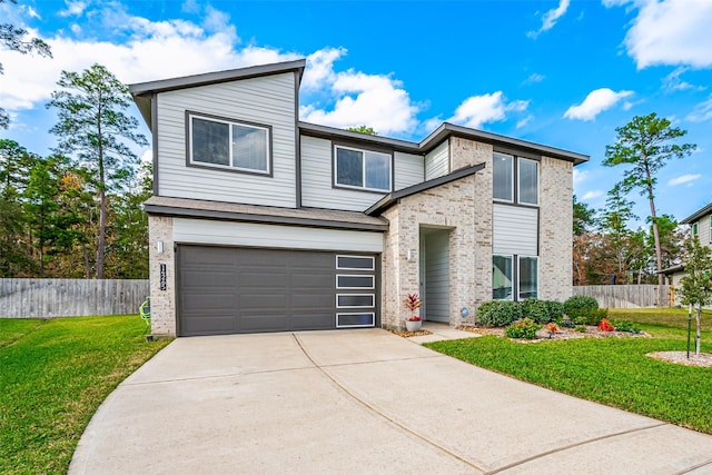 view of front of property featuring a garage, brick siding, concrete driveway, fence, and a front yard