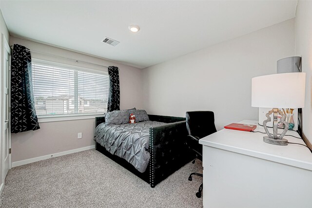 bedroom featuring light carpet