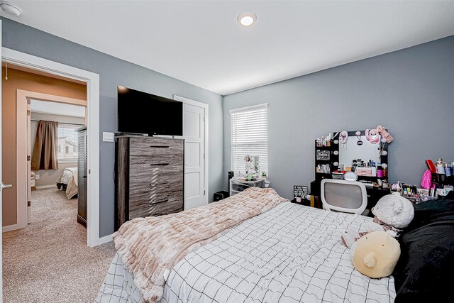 bedroom featuring light colored carpet