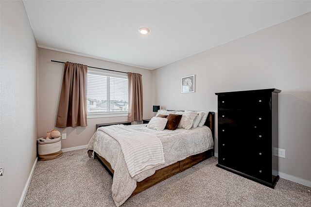 bedroom featuring light carpet