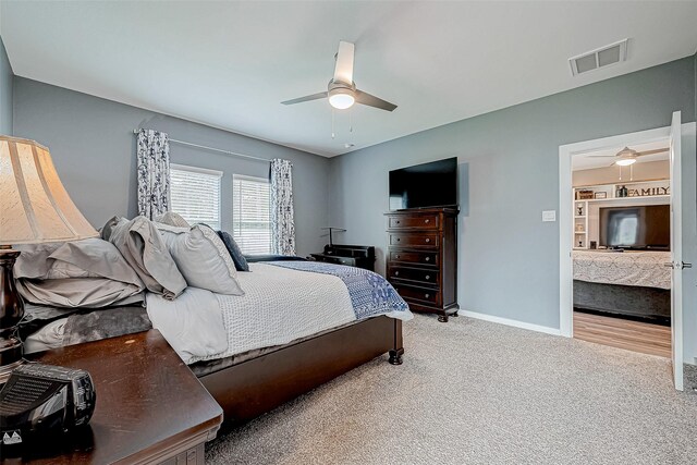 bedroom with ceiling fan and light colored carpet