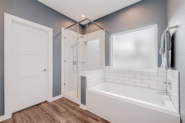 bathroom with plus walk in shower and wood-type flooring