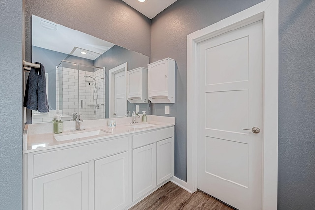 bathroom featuring a shower with door, vanity, and hardwood / wood-style flooring