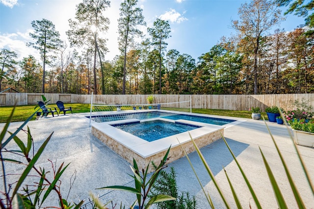 view of pool with a patio, a lawn, and an in ground hot tub