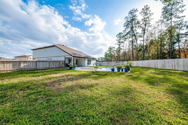 view of yard with a fenced in pool